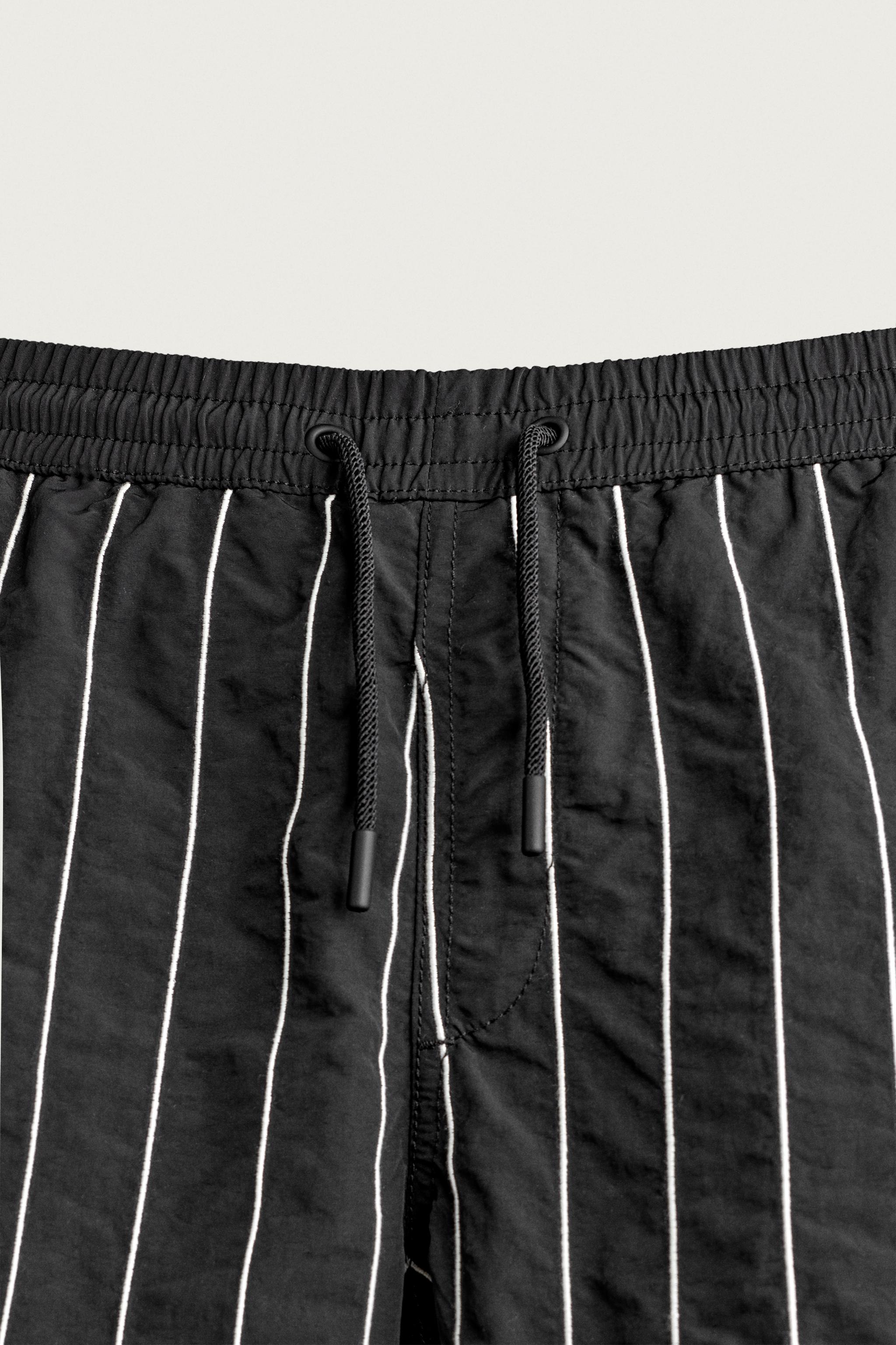 EMBROIDERED STRIPE MID-LENGTH SWIM TRUNKS